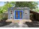 Backyard shed featuring charming blue doors and a functional awning at 957 Sharon Se Cir, Smyrna, GA 30080