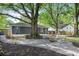Beautiful backyard with a fire pit and mature trees, perfect for outdoor entertaining and relaxing at 957 Sharon Se Cir, Smyrna, GA 30080