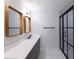 Modern bathroom features double sinks, a glass-enclosed shower, and sleek black hardware at 957 Sharon Se Cir, Smyrna, GA 30080