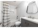 Bathroom with shower-tub combo, stylish vanity with modern fixtures, and patterned flooring at 957 Sharon Se Cir, Smyrna, GA 30080