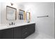 Contemporary bathroom features double sinks, dark vanity with gold hardware, and modern mirrors at 957 Sharon Se Cir, Smyrna, GA 30080