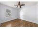 Cozy bedroom features hardwood floors, a ceiling fan, and a window at 957 Sharon Se Cir, Smyrna, GA 30080