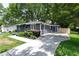 Charming single-story home with a well-manicured lawn, a long driveway, and a beautifully landscaped front yard at 957 Sharon Se Cir, Smyrna, GA 30080