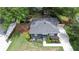 Aerial view of charming home with dark gray siding, blue door and mature landscaping at 957 Sharon Se Cir, Smyrna, GA 30080