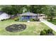 Charming single story home with landscaped front yard, featuring a blue front door and a long driveway at 957 Sharon Se Cir, Smyrna, GA 30080