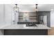 A kitchen with marble countertops, a stainless steel refrigerator, and floating wooden shelves at 957 Sharon Se Cir, Smyrna, GA 30080