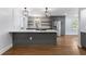 Well-lit modern kitchen features a gray island with cooktop and open shelving at 957 Sharon Se Cir, Smyrna, GA 30080