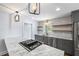 Modern kitchen featuring marble countertops, floating shelves, gray cabinets, and stainless-steel appliances at 957 Sharon Se Cir, Smyrna, GA 30080