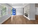 Bright living room featuring hardwood floors, a blue paneled door, and a modern fireplace at 957 Sharon Se Cir, Smyrna, GA 30080