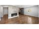 Open-concept living room featuring hardwood floors, a modern fireplace, and stainless steel appliances in kitchen at 957 Sharon Se Cir, Smyrna, GA 30080