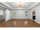 A spacious main bedroom with a tray ceiling, two windows, hardwood floors, and a barn door closet at 957 Sharon Se Cir, Smyrna, GA 30080