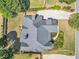 Bird's eye view of an estate showcasing the roof, lawn, landscaping, and driveway at 147 Gold Bridge Xing, Canton, GA 30114