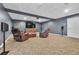 Finished basement with plush carpeting, a large screen television, comfortable seating and dimmable lighting at 147 Gold Bridge Xing, Canton, GA 30114