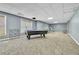 Spacious finished basement with pool table, large windows and ample room for entertaining or activities at 147 Gold Bridge Xing, Canton, GA 30114