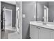 Bright bathroom featuring a white vanity and a large mirror at 147 Gold Bridge Xing, Canton, GA 30114