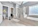 Modern bathroom featuring a walk-in shower, soaking tub, and access to a walk-in closet at 147 Gold Bridge Xing, Canton, GA 30114