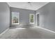 Empty bedroom with a ceiling fan and large windows for natural light at 147 Gold Bridge Xing, Canton, GA 30114