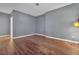 Empty room with wood floors and light-gray walls at 147 Gold Bridge Xing, Canton, GA 30114