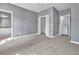 Light-filled bedroom with ample closet space and neutral carpet at 147 Gold Bridge Xing, Canton, GA 30114