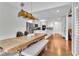 Light-filled dining area with a unique chandelier and view into the modern kitchen at 147 Gold Bridge Xing, Canton, GA 30114