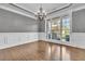 Elegant dining room with hardwood floors, a tray ceiling, wainscoting, and large windows for ample light at 147 Gold Bridge Xing, Canton, GA 30114