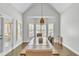 Dining room boasts a vaulted ceiling, a hanging light fixture, and a view of the backyard at 147 Gold Bridge Xing, Canton, GA 30114
