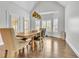 Open dining room featuring large windows, wood floors, and a rustic wooden table at 147 Gold Bridge Xing, Canton, GA 30114