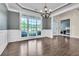 Formal dining area with hardwood floors, wainscoting, tray ceiling, and large windows for natural light at 147 Gold Bridge Xing, Canton, GA 30114