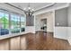 Formal dining room featuring hardwood floors, wainscoting, tray ceiling, and large windows for natural light at 147 Gold Bridge Xing, Canton, GA 30114