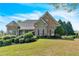 Traditional home with a manicured lawn, mature trees, and attractive stone accents on the facade at 147 Gold Bridge Xing, Canton, GA 30114