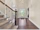 Elegant foyer with hardwood floors, staircase, and a bright, welcoming entrance with a glass-paneled door at 147 Gold Bridge Xing, Canton, GA 30114