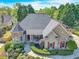 Stunning home with stone accents, lush landscaping, and a welcoming front porch at 147 Gold Bridge Xing, Canton, GA 30114