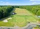 Aerial view featuring a golf course, green spaces, trees and the back of a home at 147 Gold Bridge Xing, Canton, GA 30114