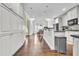 Bright kitchen showcases modern white cabinetry and a view into the dining area at 147 Gold Bridge Xing, Canton, GA 30114
