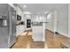Spacious kitchen with white cabinetry, stainless steel appliances, and a center island with countertop seating at 147 Gold Bridge Xing, Canton, GA 30114