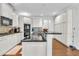 Well-lit kitchen features white cabinetry, granite countertops, and stainless steel appliances at 147 Gold Bridge Xing, Canton, GA 30114