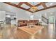 Spacious living room with hardwood floors, a beamed ceiling, and an open floor plan at 147 Gold Bridge Xing, Canton, GA 30114