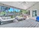 Relaxing screened-in porch with white furniture, ceiling fan, and views of the wooded backyard at 147 Gold Bridge Xing, Canton, GA 30114