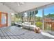 Bright screened-in porch with white furniture and views of the greenery at 147 Gold Bridge Xing, Canton, GA 30114