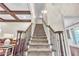 Carpeted staircase with decorative railings and coffered ceiling at 147 Gold Bridge Xing, Canton, GA 30114