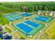 Overhead view of well-maintained tennis courts, fenced and surrounded by trees at 147 Gold Bridge Xing, Canton, GA 30114