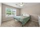 Cozy bedroom with a ceiling fan, carpeted floor, and a large window providing natural light at 2060 Ellison Nw Way # 11, Kennesaw, GA 30152