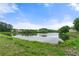 Picturesque lake view showcasing the calm waters and lush green shoreline with surrounding trees at 2060 Ellison Nw Way # 11, Kennesaw, GA 30152