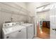 Convenient laundry room with modern appliances and plenty of shelving space for storage at 2060 Ellison Nw Way # 11, Kennesaw, GA 30152