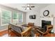 Bright living room featuring hardwood floors, a fireplace, and lots of natural light from large windows at 2060 Ellison Nw Way # 11, Kennesaw, GA 30152