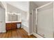 Main bathroom with a vanity, soaking tub, and glass shower featuring modern fixtures at 2060 Ellison Nw Way # 11, Kennesaw, GA 30152