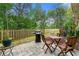 Outdoor patio featuring a stone tile surface, grill, and outdoor dining set for relaxing or entertaining at 2060 Ellison Nw Way # 11, Kennesaw, GA 30152