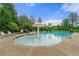 Community swimming pool featuring a mushroom fountain and plenty of lounge chairs under a blue sky at 2060 Ellison Nw Way # 11, Kennesaw, GA 30152
