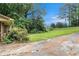 A wide-open lawn area on the side of the house with overgrown vegetation at 2214 River Rd, Ellenwood, GA 30294