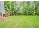Large, grassy backyard, partially fenced, with a deck leading to the home's back entrance at 2326 Westland Way, Acworth, GA 30102